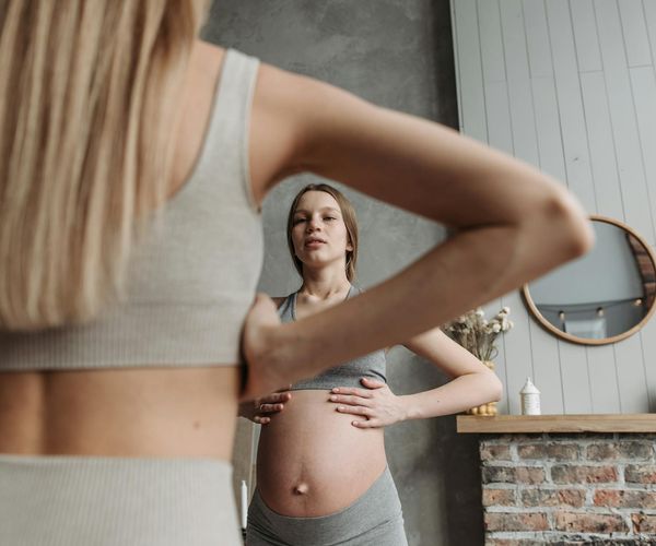 A serene group of pregnant women practicing gentle yoga.